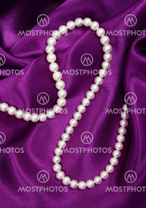 White pearls on a lilac silk