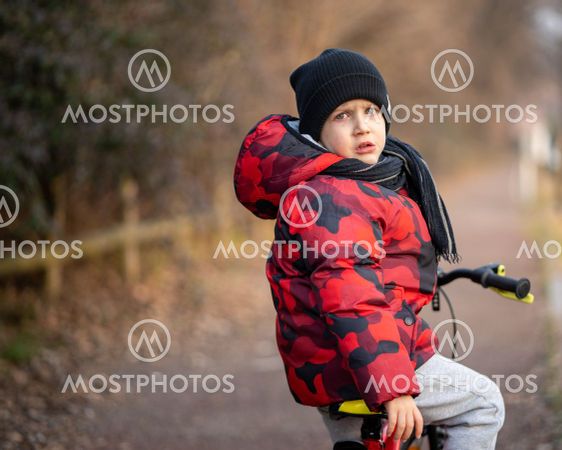 Sad kid on bicycle at park