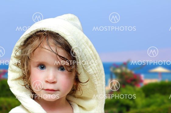 cute girl in bathrobe on beach
