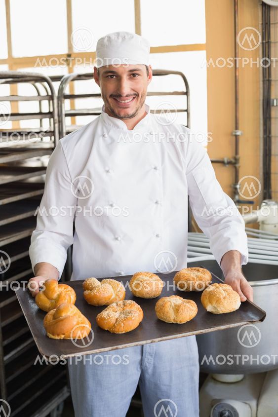 Baker showing tray of rolls