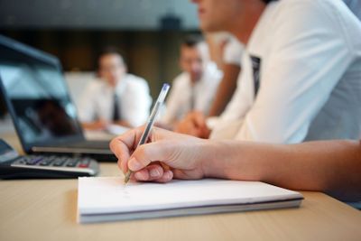Hand of a man writing on a document