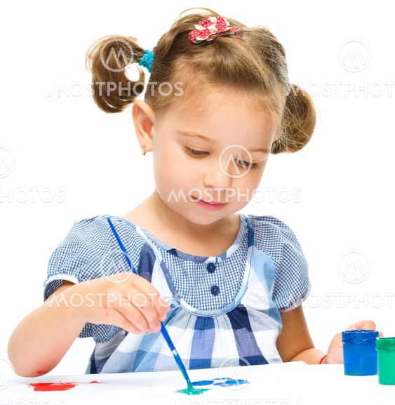 Little girl is painting with gouache