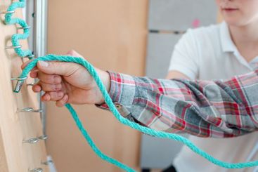 Man in occupational therapy with therapist training his...
