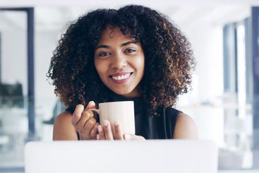 Laptop, coffee and portrait of business woman for on...