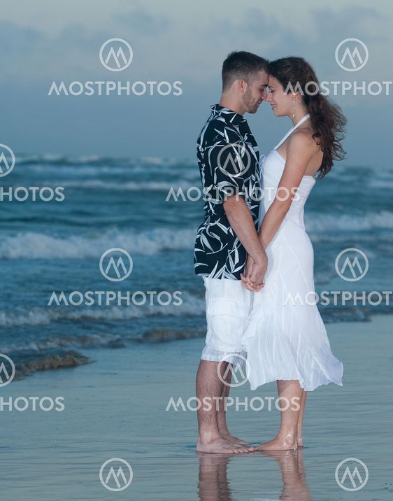 Couple holding hands on beach