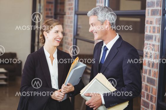 Happy business people discussing at office