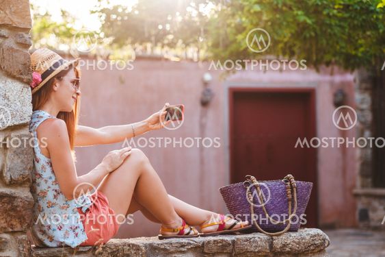 Tourist woman taking travel selfie photos with smartphone...