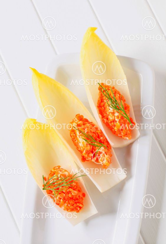 Red lentil salad on fresh endive leaves