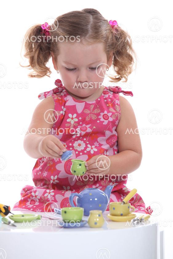 little girl playing at tea party