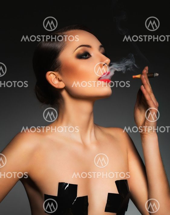 Portrait of a beautiful woman with cigar and with a glamorous retro makeup