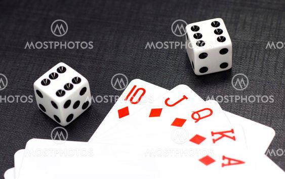 Dices and playing cards on a black background