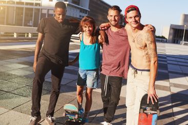 Happy, people and skateboard for fitness in city of...