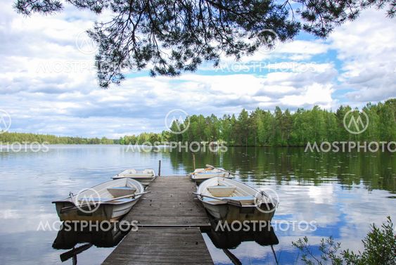 Wooden pier with rowing boats