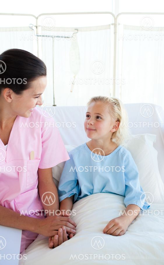 Smiling nurse carrying a little female patient