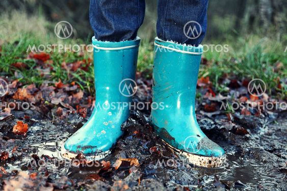 Fall / Autumn concept - Rain boots in mud puddle
