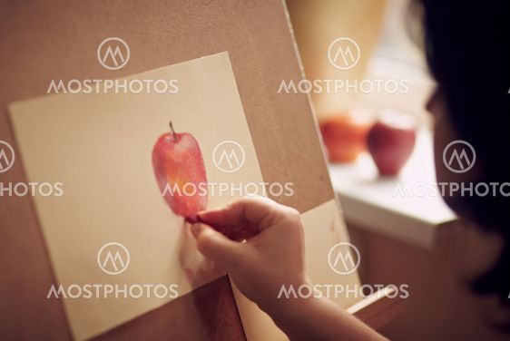 Woman draws an apple