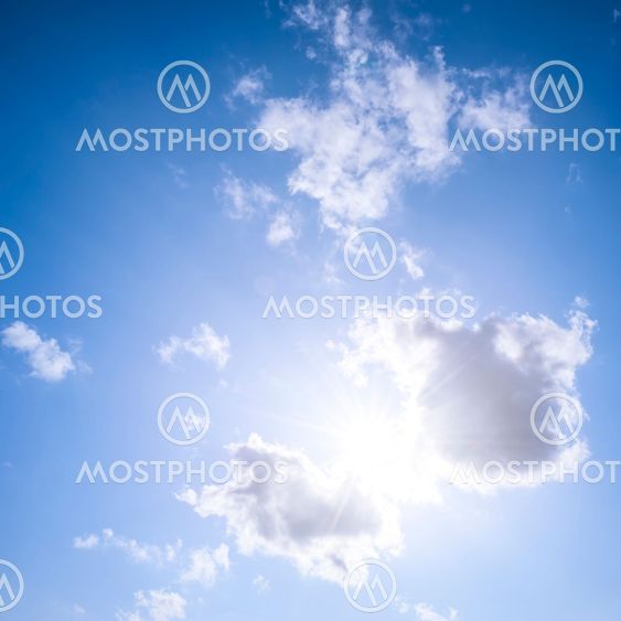 Blue sky with sun and clouds