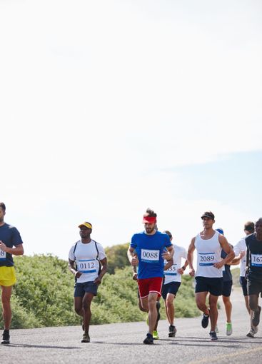 Competition, people and running group in road for...