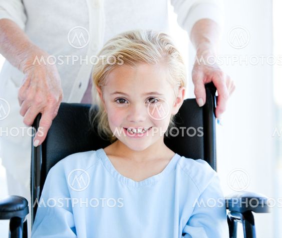 Adorable little girl sitting on a wheelchair
