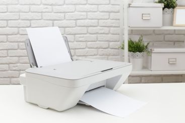 Home office printer outputting documents in a bright...