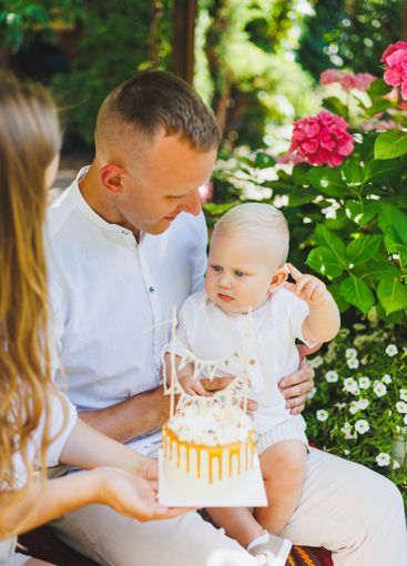 Mom and dad in nature with their one-year-old son...