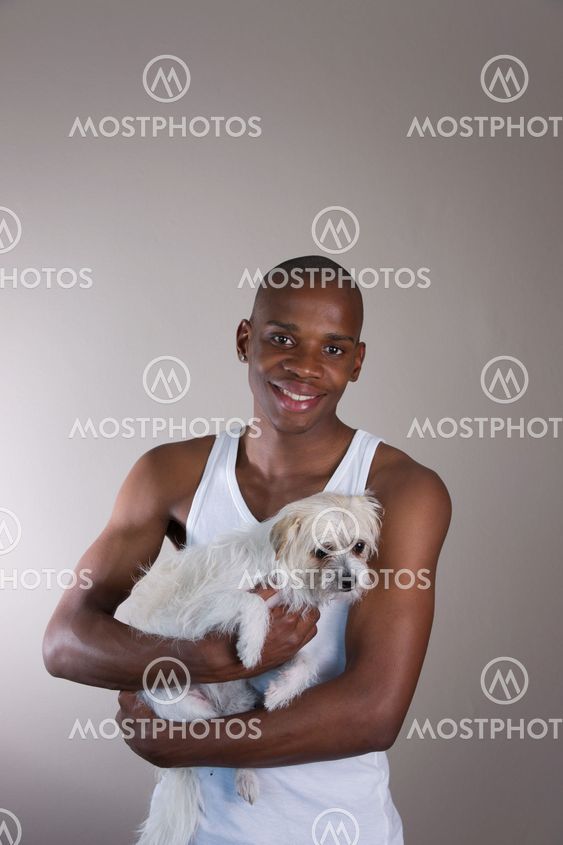 Smiling African man with a dog