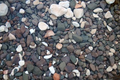 a full frame image of different colored rocks and pebbles...