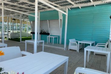 Interior of a summer wooden restaurant with tables...