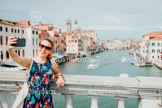 Young woman using smartphone in Venice, Italy