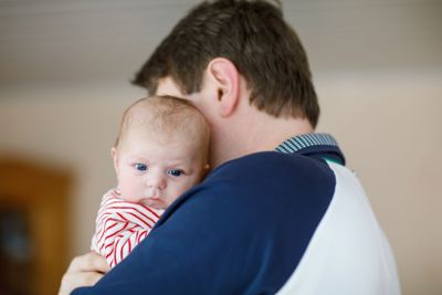 Happy proud young father with newborn baby daughter,...