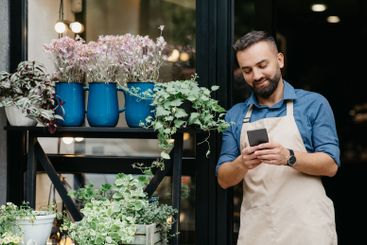Portrait of young caucasian male owner of flower center...