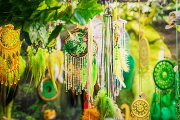Vibrant decorations with beads and feathers dangle...