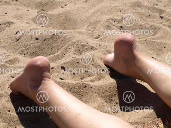Female legs on beach
