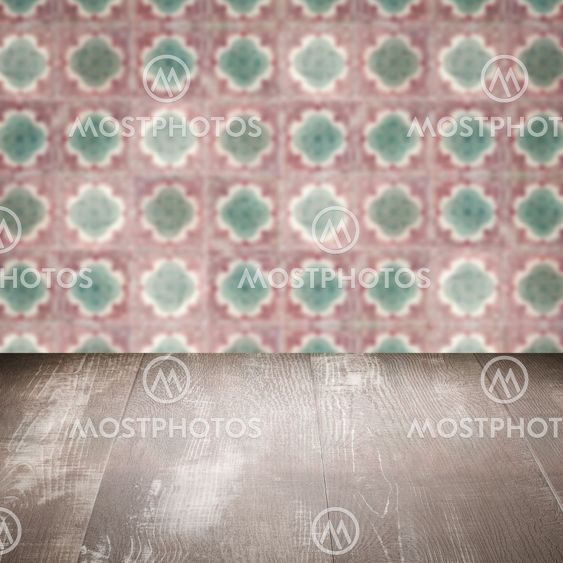 Wood table top and blur vintage ceramic tile pattern wall