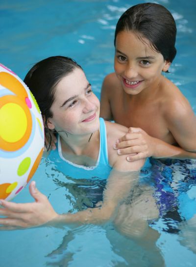Brother and sister playing in a swimming pool