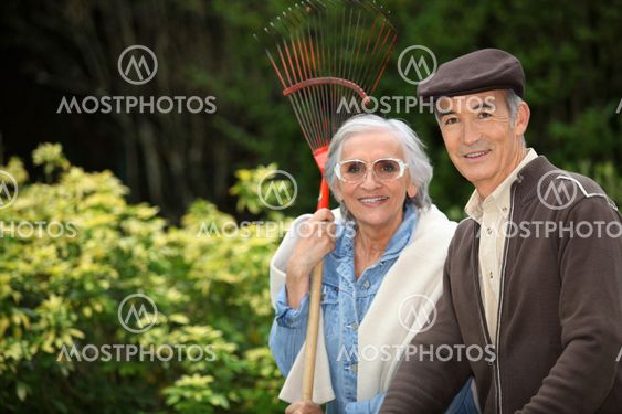Smiling senior couple gardening