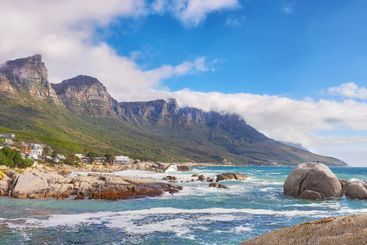 Ocean, houses and mountain with landscape, sky and...