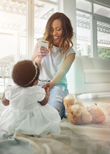 Happy woman, baby and cellphone for childhood...