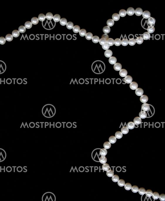 White pearls on the black velvet background