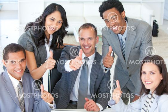 Business team with thumbs up in office