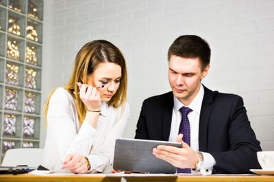 young business colleagues discussing work on a laptop...