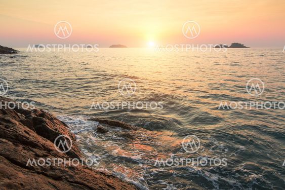 Sunset on a tropical rocky shore.