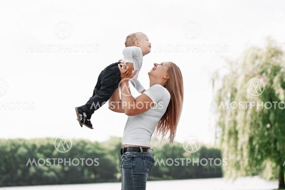 mother plays with her son while walking in the Park