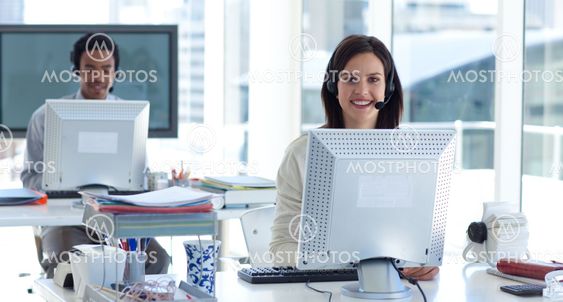 Beautiful brunette businesswoman working in a call center