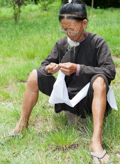 old woman sewing