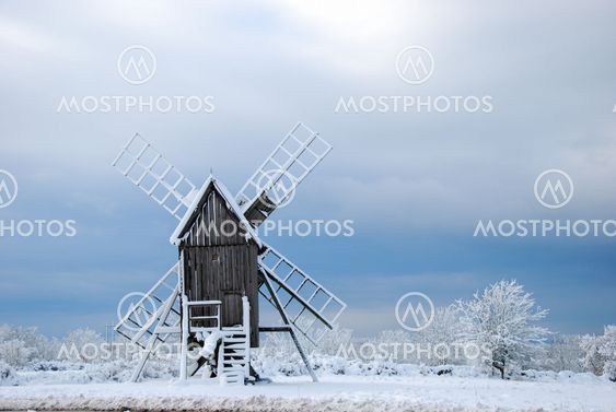 Winter landscape with an old wooden windmill