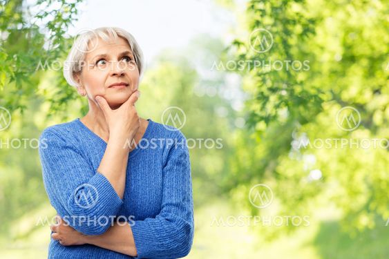 senior woman thinking over natural background