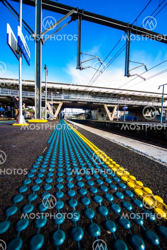 Morning at train station platform with safety dots
