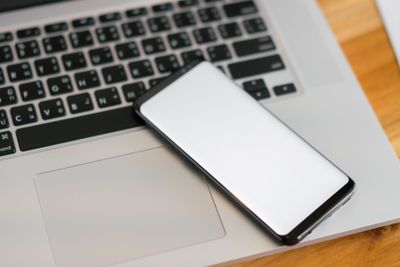 laptop with smart phone on table .