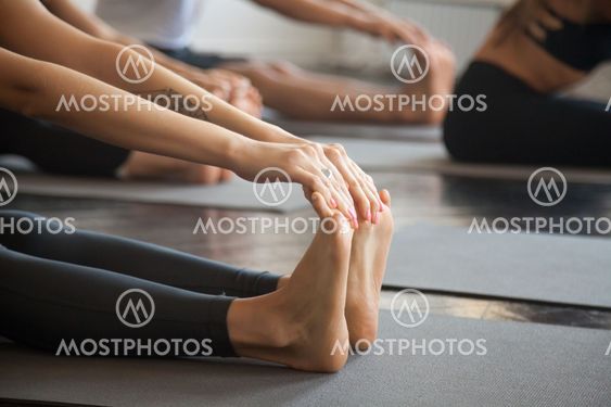 Close up of female feet, paschimottanasana pose